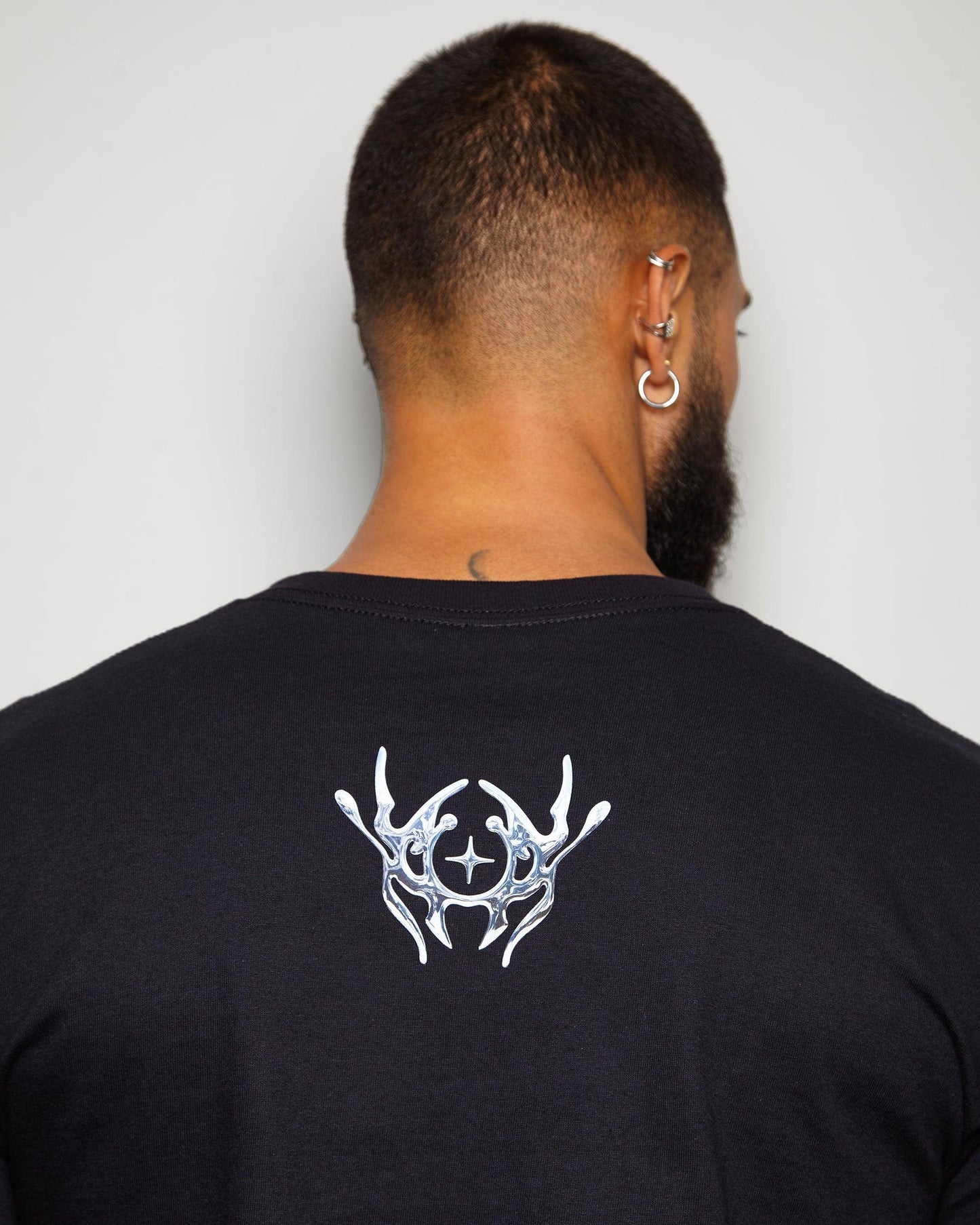 NXS006: Silver style print on black tee.