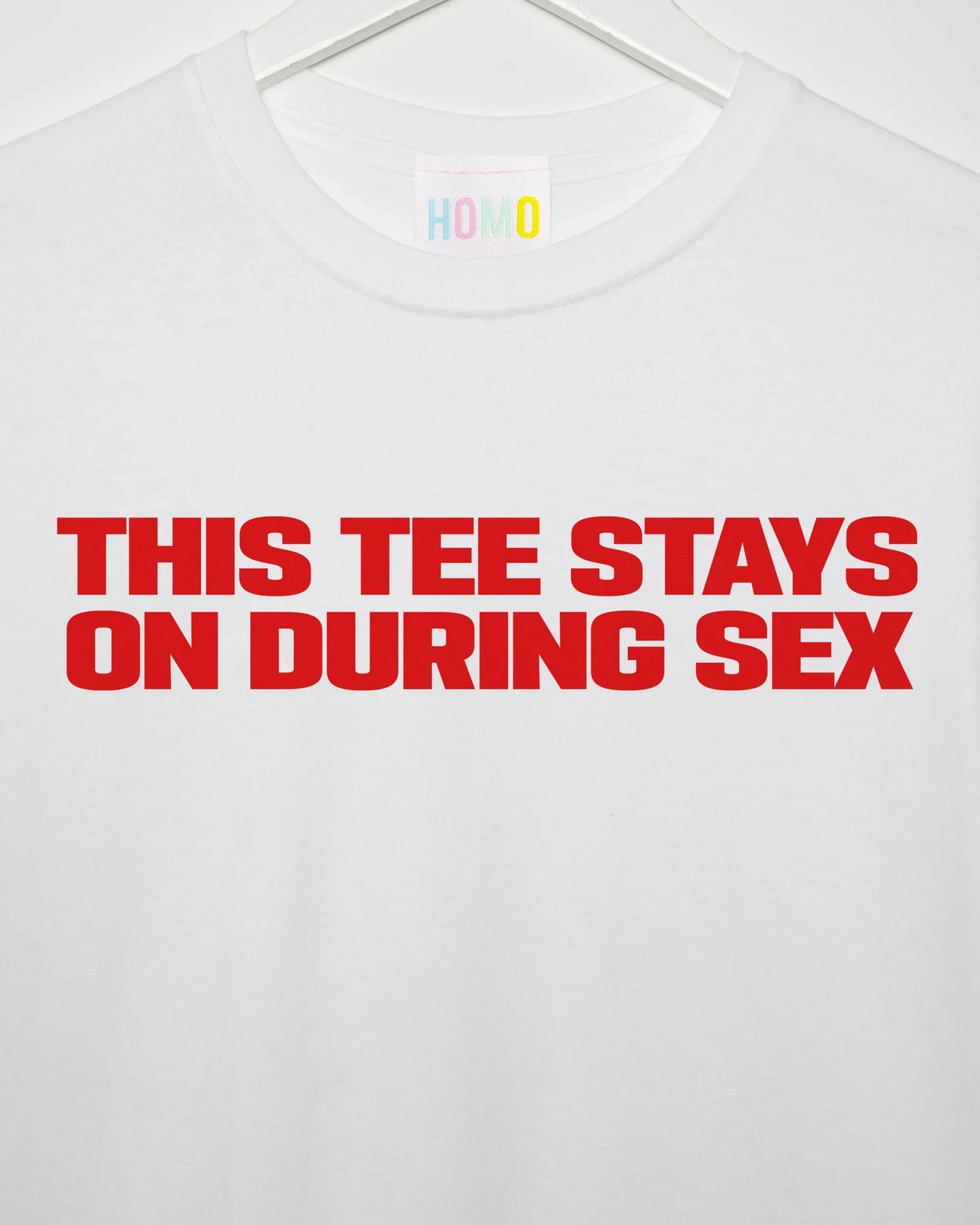 Slogan tee: This t-shirt stays on, red print on white t-shirt