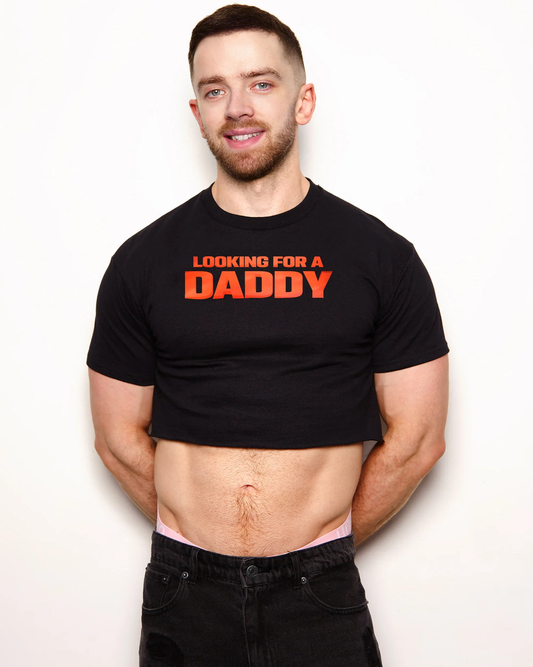 Man wearing a black t-shirt with 'Looking for a Daddy' text on a white background