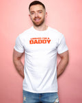 Man wearing a white t-shirt with 'Looking for a Daddy' text on a pink background