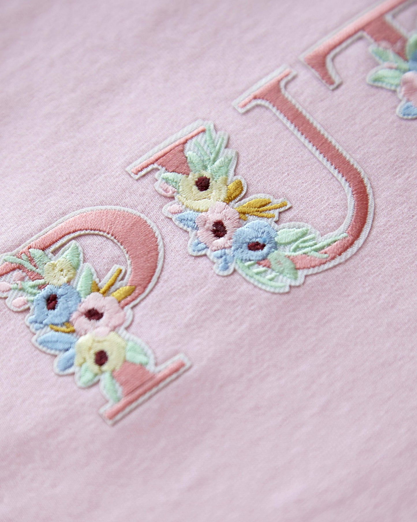 Floral style puta embroidery on pink - sleeveless crop top.