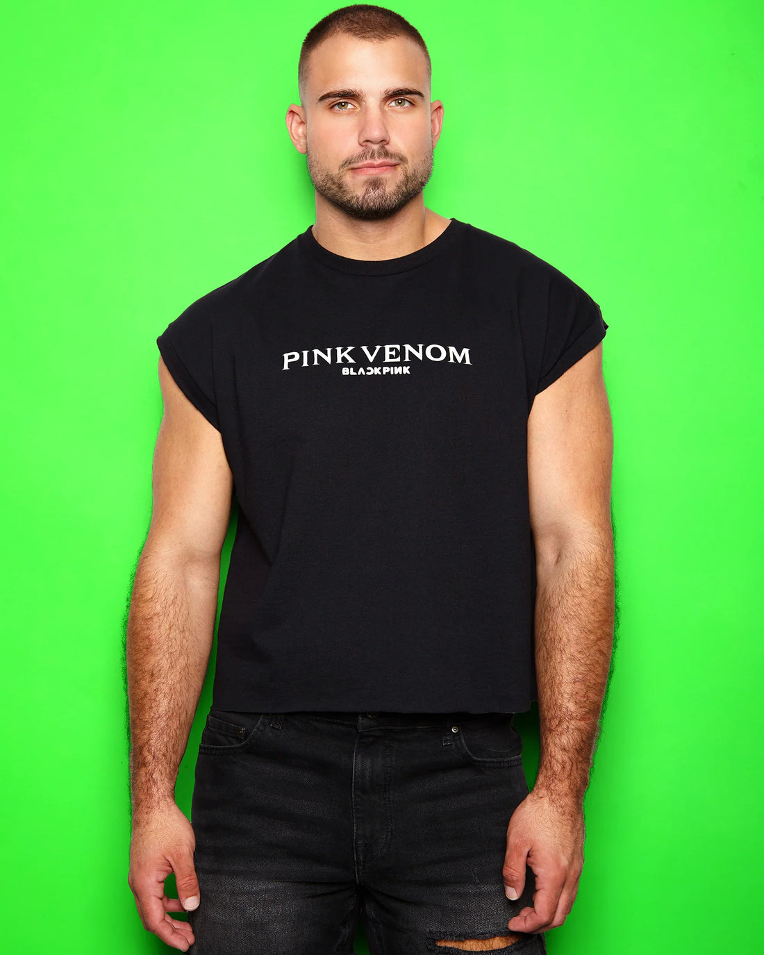 Man wearing a black sleeveless shirt with 'Pink Venom' text on a green background