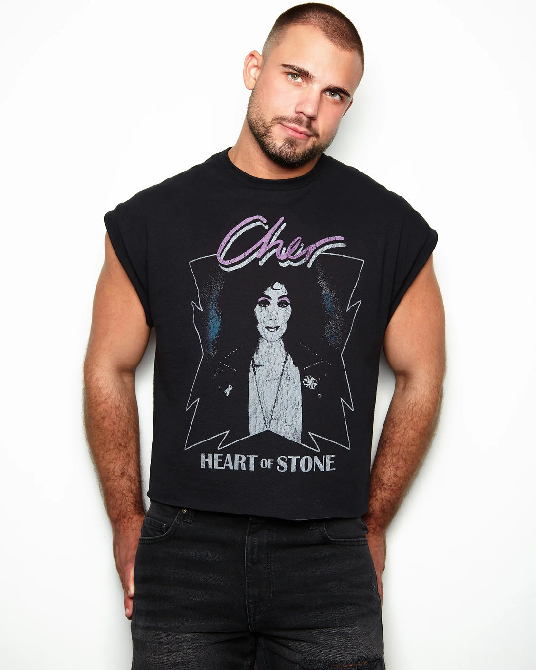 Man wearing a black sleeveless shirt with Cher Heart of stone 1989 tour on a white background