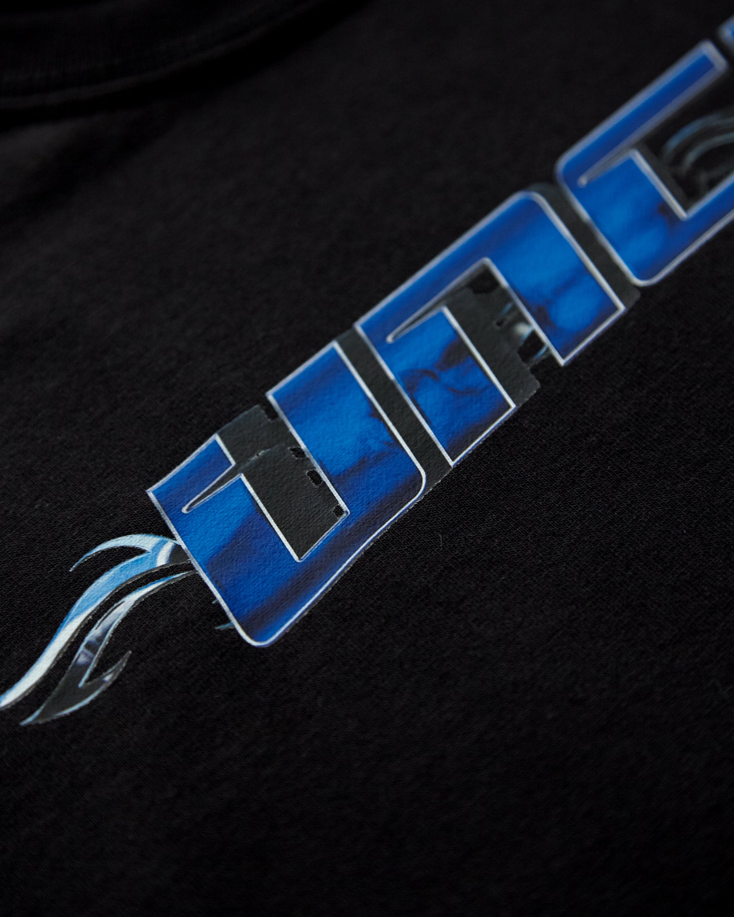 Chrome Y2K: UNCUT, blue and silver on black - tee.
