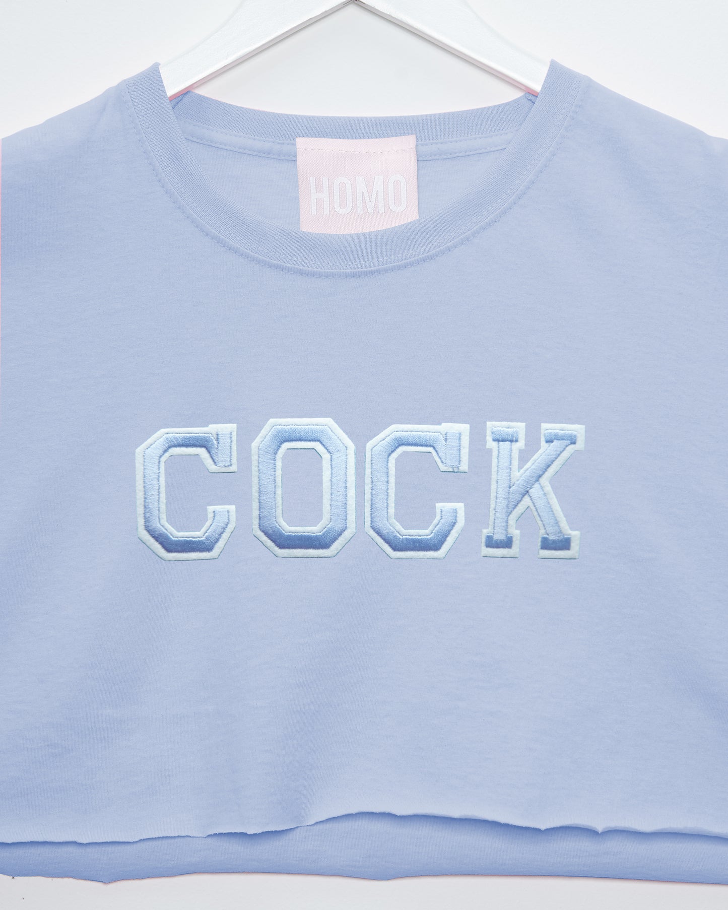 Varsity style cock embroidery on light blue - sleeveless crop top.